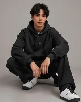 Model crouching wearing relaxed lifestyle hoodie outfit