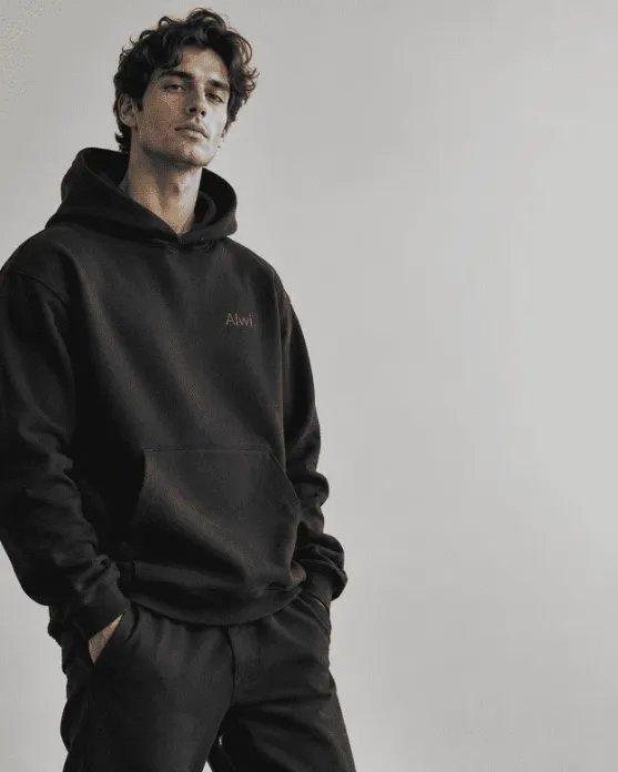 A model wearing a monochrome Alwi hoodie